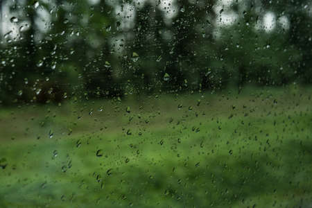 Drops on the glass on the train. On a long trip heavy rainの写真素材