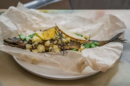 fish baked in parchment with cheese, herbs and lemonの写真素材