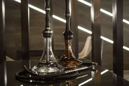 Beautiful glass hookah on a wooden table in a hookah bar