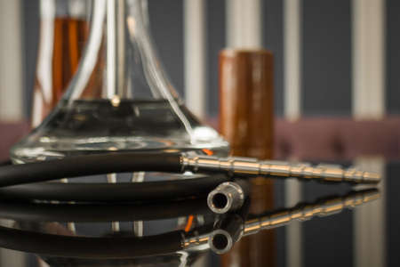 Beautiful glass hookah on a wooden table in a hookah bar