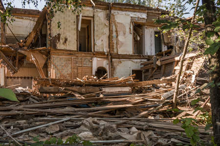 Old ruined wooden house. Two-story building intended for demolition. Summer dayの写真素材