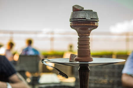 Beautiful new hookah on the table on the summer terrace. Hookah Russian production. Summer day