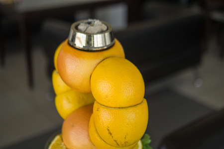 Beautiful glass hookah, with a fruit bowl, consisting of oranges and grapefruit. Handmade in a flask green syrup and lemonsの写真素材