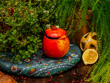 Alcoholic cocktail poured inside pomegranate. Pomegranate is used as a glass. Tropical flavorの写真素材
