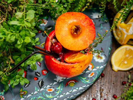 Alcoholic cocktail poured inside pomegranate. Pomegranate is used as a glass. Tropical flavorの写真素材