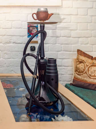 New hookah on a table in an oriental cafe. A variety of flavors of tobacco.