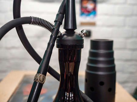 New hookah on a table in an oriental cafe. A variety of flavors of tobacco.