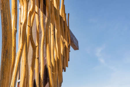 The sky is visible through the wooden texture of the bungalow on the island. Sunny dayの写真素材