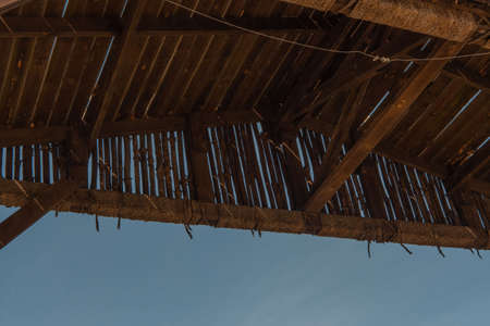 The sky is visible through the wooden texture of the bungalow on the island. Sunny dayの写真素材