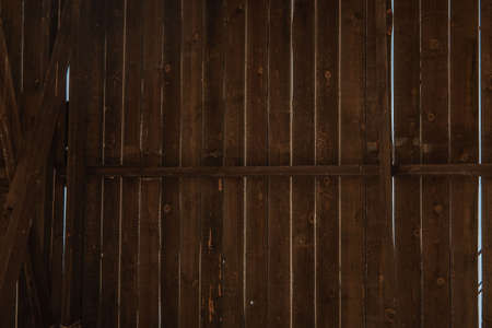 The sky is visible through the wooden texture of the bungalow on the island. Sunny day