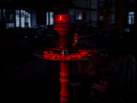 Hookah in red lighting in a cafe. Eastern traditions. Barの写真素材