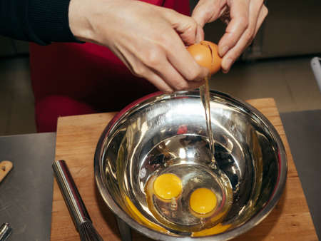 The process of making pancakes. Cook in the kitchen makes the dough.の写真素材