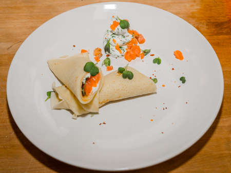 Delicious hot pancakes with various fillings on the table.の写真素材