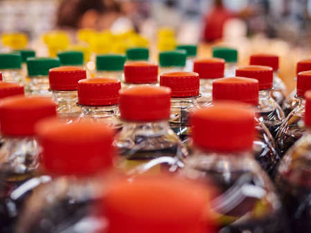 Bottled lemonade on shelves in a supermarket. A lot of bottlesの写真素材