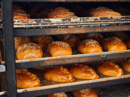 Freshly baked bread on trays in a self-catering supermarket.の写真素材