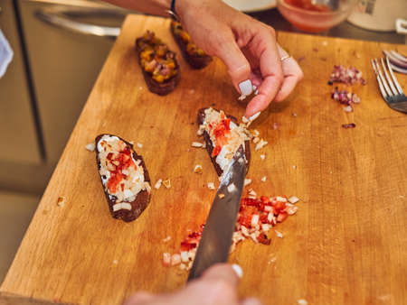 The process of making delicious bruschetta on crispy toasted bread. Femaleの写真素材