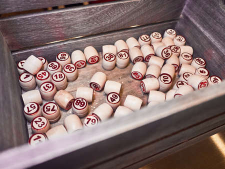 Wooden lotto barrels in a wooden box. Family game,の写真素材