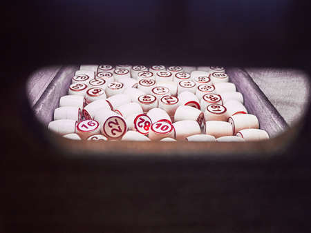 Wooden lotto barrels in a wooden box. Family game,の写真素材