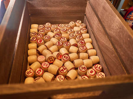 Wooden lotto barrels in a wooden box. Family game,の写真素材