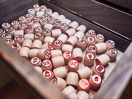 Wooden lotto barrels in a wooden box. Family game,の写真素材