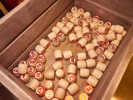 Wooden lotto barrels in a wooden box. Family game,の写真素材