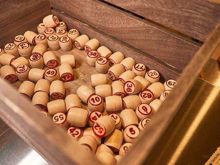 Wooden lotto barrels in a wooden box. Family game,の写真素材