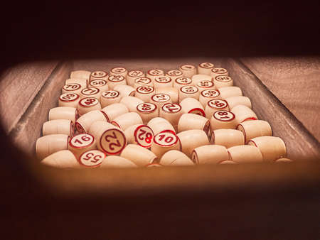 Wooden lotto barrels in a wooden box. Family game,の写真素材