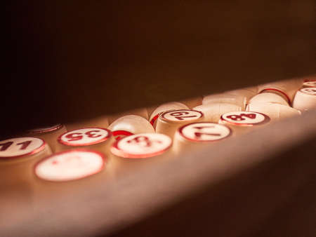 Wooden lotto barrels in a wooden box. Family game,の写真素材