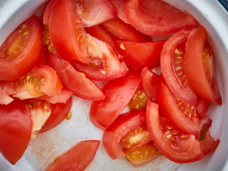 Sliced tomato in a white plate. vegetables, healthy foodの写真素材