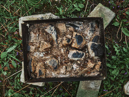 Brazier after barbecue. Burning out coals and ash at the bottom of the barbecue.の写真素材