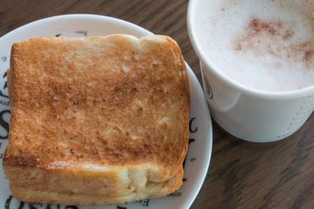 A cup of hot coffee and breadの写真素材