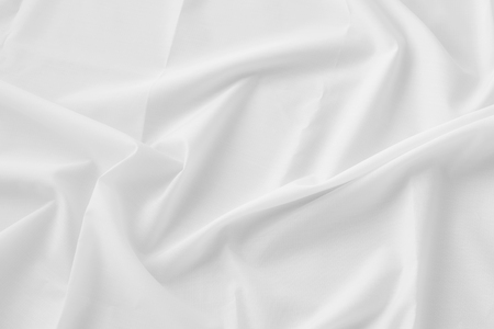 Creased white cloth material fragment as a backgroundの写真素材