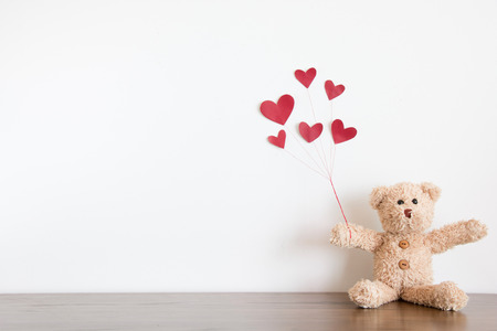 Teddy bear with red heart balloonの写真素材