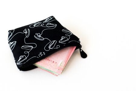 The purse black & white color and money inside isolated white backgroundの写真素材