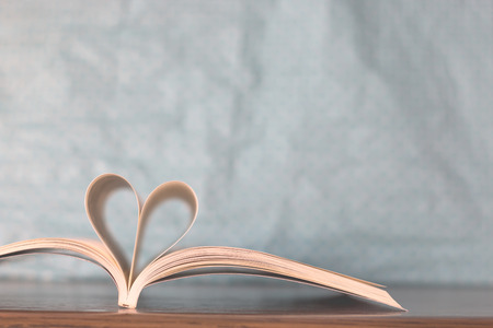 Open book with pages forming heart shapeの写真素材