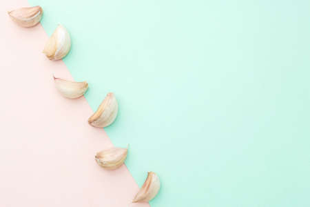 A garlic isolated on pastel color backgroundの写真素材