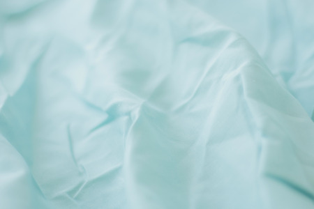 Texture of fabric is blue color background,Wavy folds of cloth.の写真素材