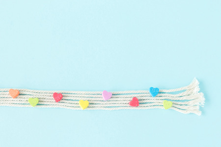 Sweet mini hearts in colorful on white rope  in pastel  backgroundの写真素材