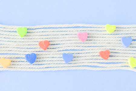 Sweet mini hearts in colorful on white rope  in pastel  backgroundの写真素材