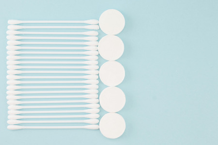 Facial mask sheets compressed type and White cotton buds on blue background