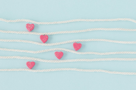Sweet mini hearts in colorful on white rope  in pastel  background