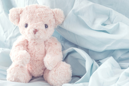 Cute teddy bear playful with fabric ,Happy feel conceptの写真素材
