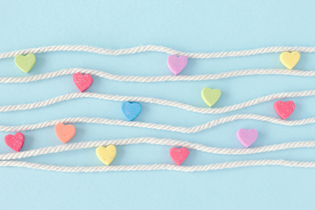 Sweet mini hearts in colorful on white rope in pastel backgroundの写真素材