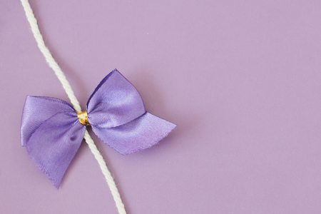 Purple bow, Christmas decoration on a pastel background