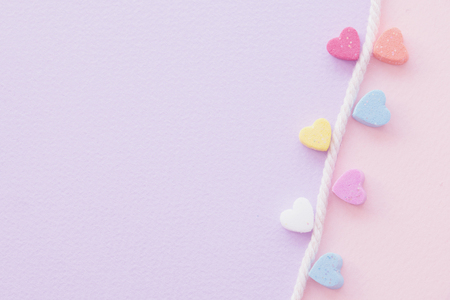 Sweet mini hearts in colorful on white rope in pastel backgroundの写真素材