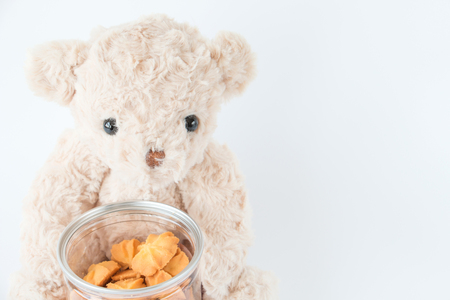 Cute teddy bear holding mini cookies vanilla tasty dessertの写真素材