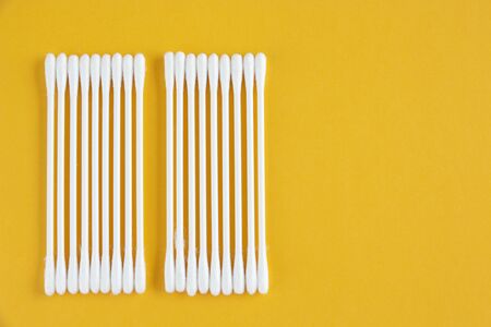 White cotton buds on pastel background