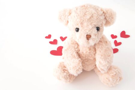 The cute little teddy bear is so happy with many hearts in valentine.の写真素材