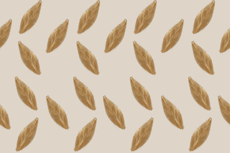 Seamless brown leaves icons on a pastel backgroundの写真素材