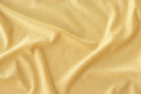 Creased yellow cloth material as a backgroundの写真素材